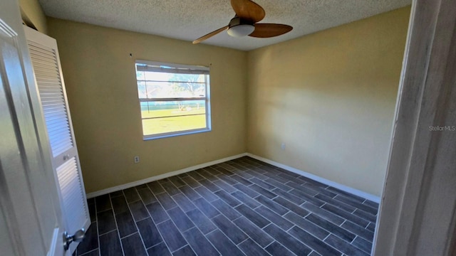 unfurnished room featuring ceiling fan and a textured ceiling