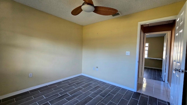 unfurnished room featuring a textured ceiling and ceiling fan