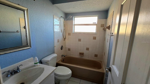 full bathroom featuring vanity, a textured ceiling, tile patterned floors, toilet, and tiled shower / bath