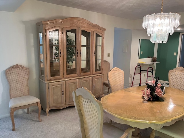 dining area with light carpet and a notable chandelier