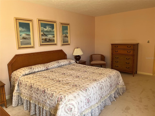 bedroom featuring carpet flooring, a textured ceiling, and baseboards