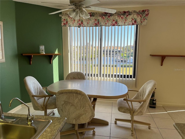 dining area with tile patterned flooring and a ceiling fan