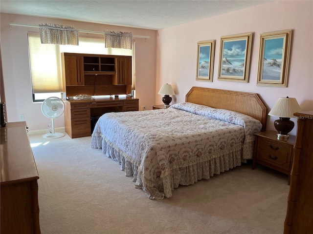 bedroom featuring light colored carpet and baseboards