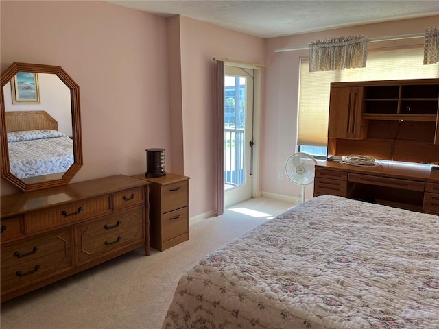 bedroom featuring access to outside, light colored carpet, and baseboards