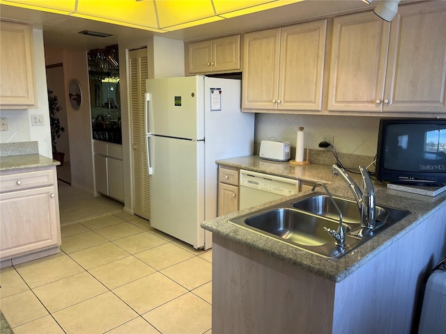 kitchen with light tile patterned flooring, light brown cabinets, white appliances, a sink, and decorative backsplash