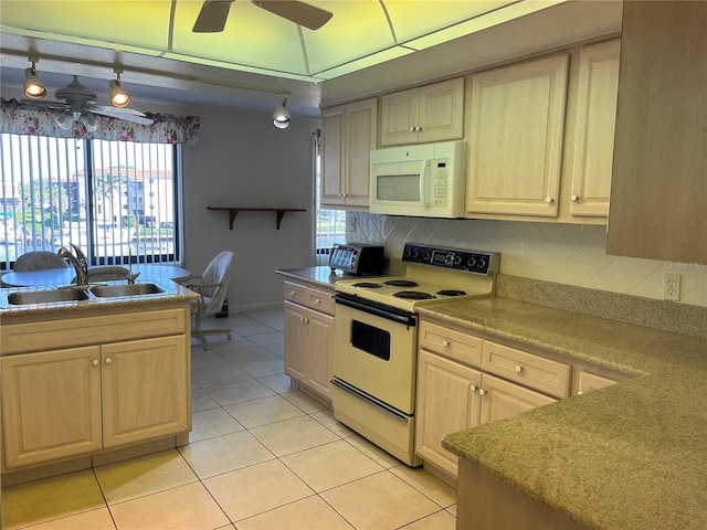 kitchen featuring light tile patterned floors, tasteful backsplash, a sink, ceiling fan, and white appliances