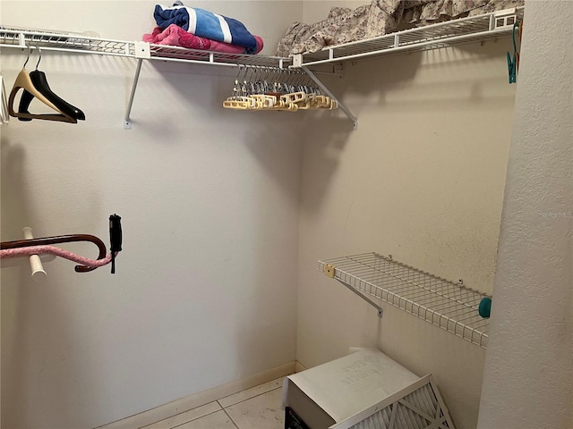 spacious closet featuring light tile patterned flooring