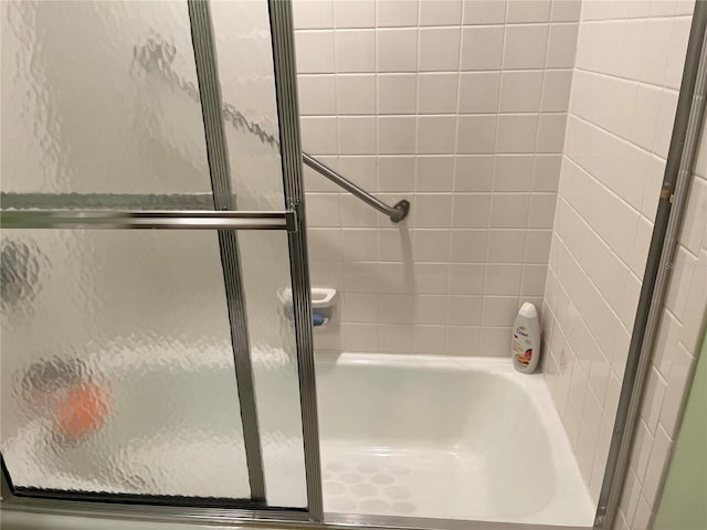 full bath with a bathing tub and a shower with shower door