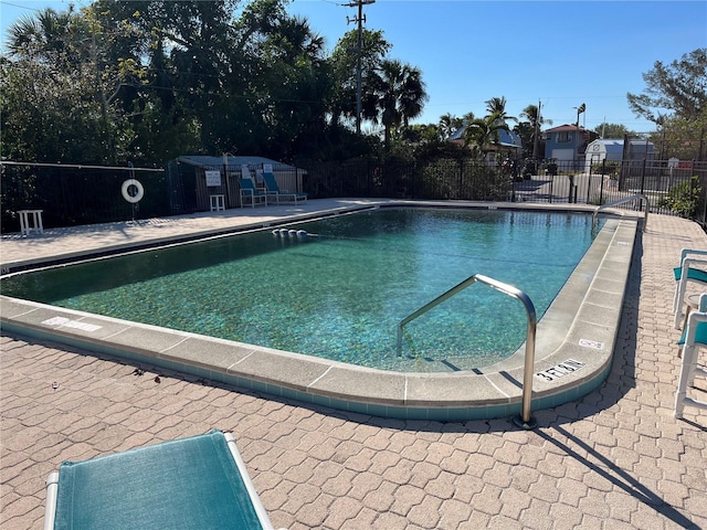 community pool featuring a patio and fence