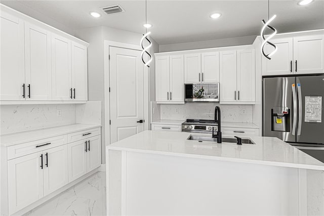 kitchen with marble finish floor, stainless steel appliances, visible vents, and decorative light fixtures