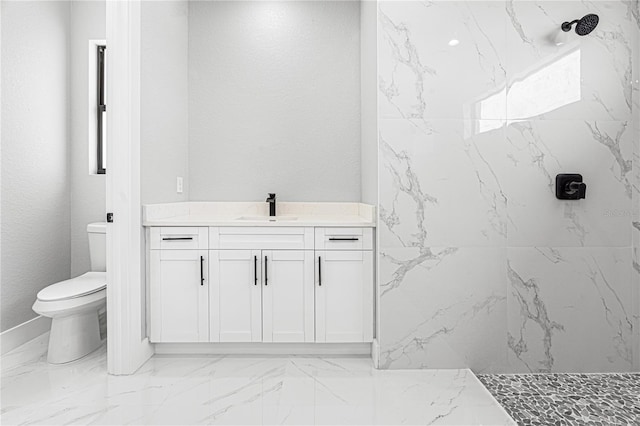 full bathroom featuring marble finish floor, a marble finish shower, a textured wall, toilet, and vanity