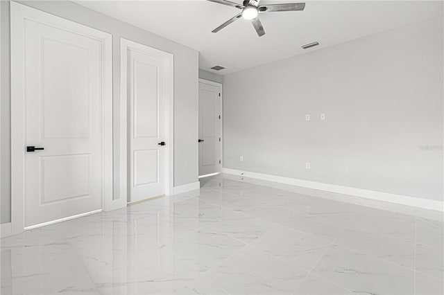 unfurnished bedroom with marble finish floor, visible vents, ceiling fan, and baseboards