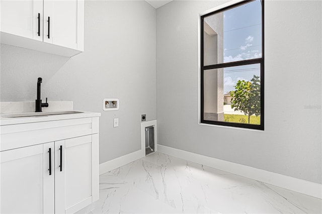 laundry area with hookup for a washing machine, a sink, baseboards, cabinet space, and electric dryer hookup