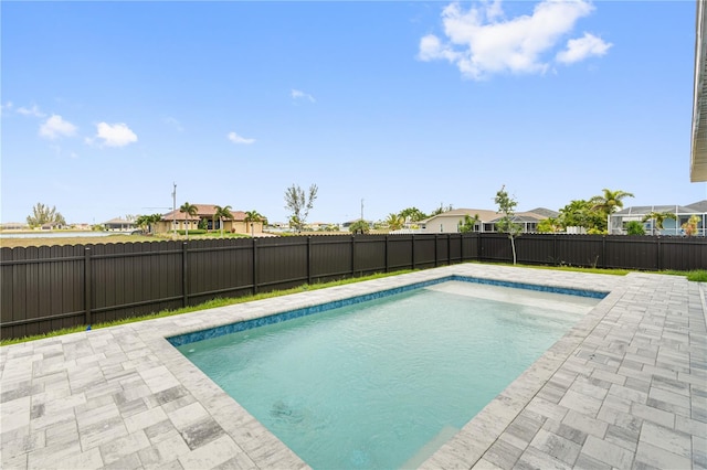 view of swimming pool featuring a patio area, a fenced backyard, a residential view, and a fenced in pool