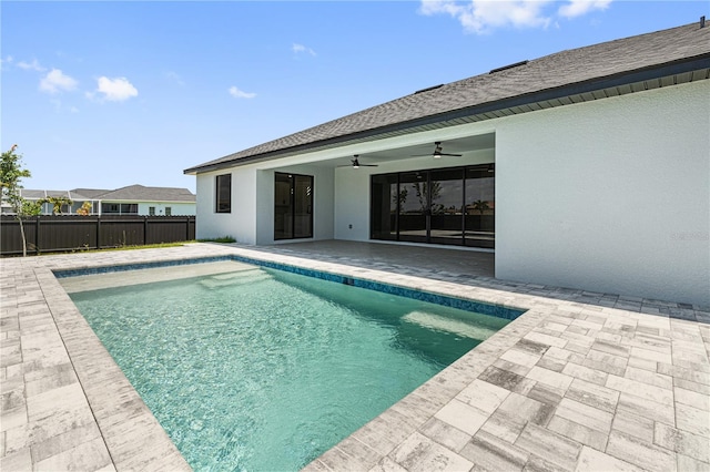 view of swimming pool with a patio area, ceiling fan, fence, and a fenced in pool