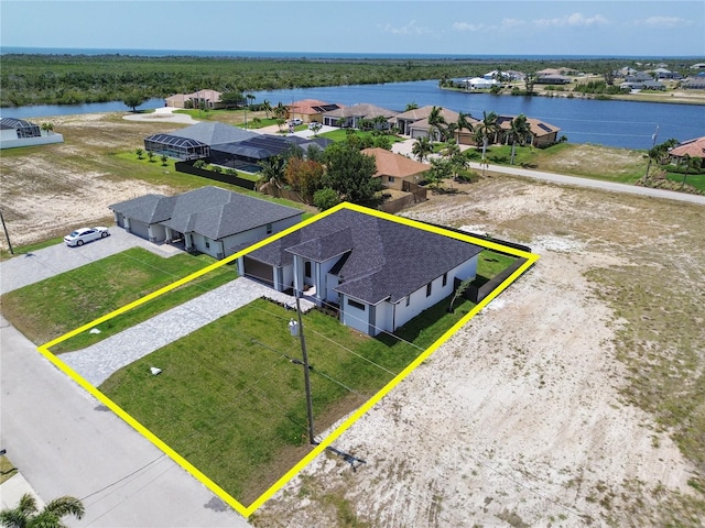 drone / aerial view featuring a residential view and a water view