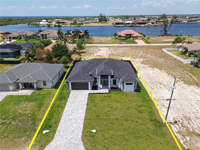 birds eye view of property featuring a water view and a residential view