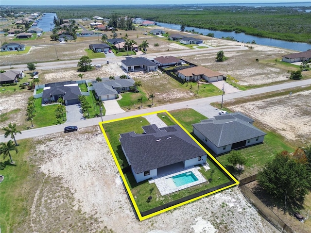 aerial view featuring a water view and a residential view