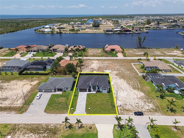 bird's eye view featuring a water view and a residential view