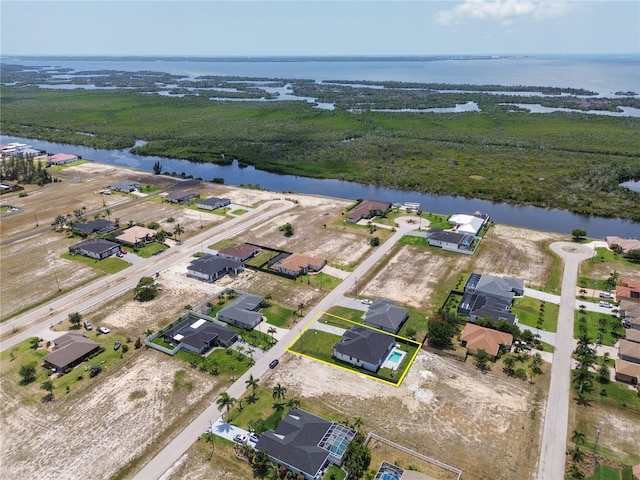 drone / aerial view featuring a residential view and a water view