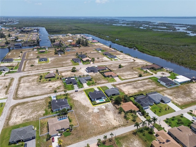 drone / aerial view with a water view and a residential view