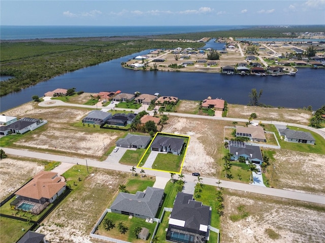 birds eye view of property featuring a residential view and a water view