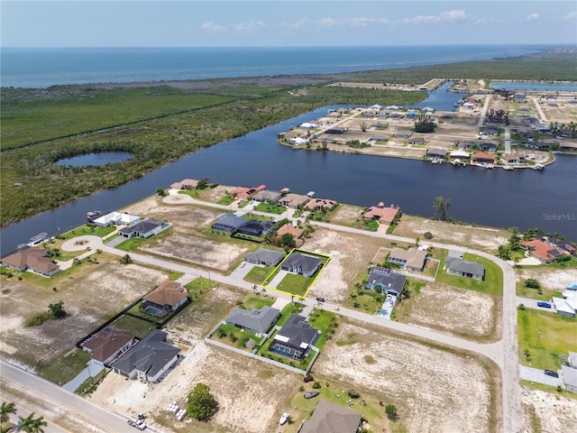 birds eye view of property featuring a water view and a residential view