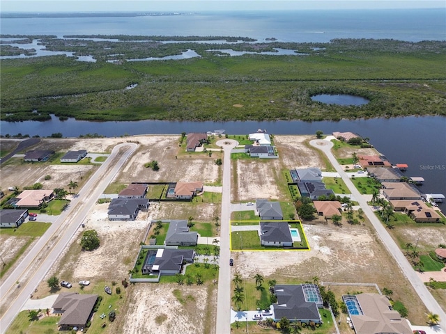 bird's eye view featuring a residential view and a water view