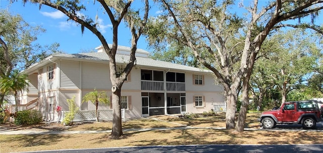 rear view of property featuring a sunroom