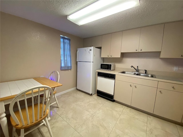 kitchen featuring sink, a textured ceiling, and white appliances