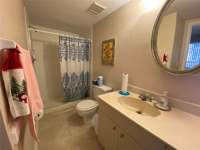 bathroom featuring vanity, toilet, and curtained shower