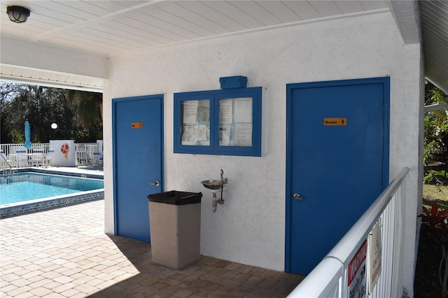 entrance to property with a patio and a community pool