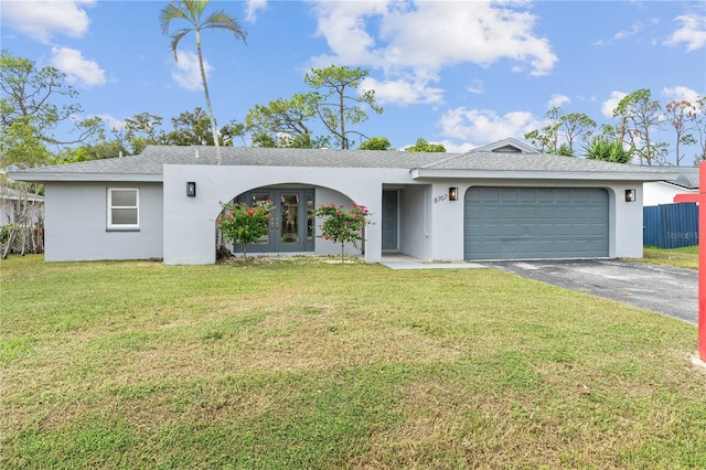 single story home featuring a front lawn, aphalt driveway, and stucco siding