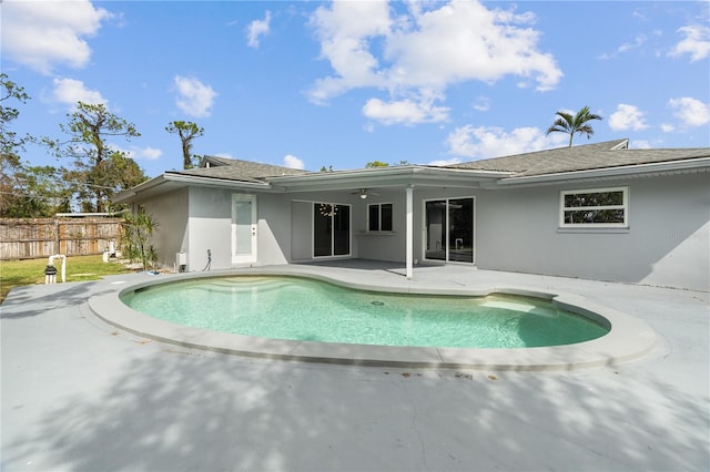 view of swimming pool featuring ceiling fan, a patio area, fence, and a fenced in pool