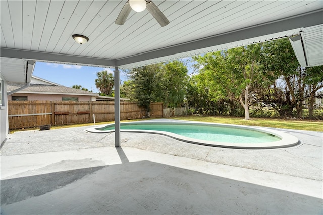 view of swimming pool featuring a fenced in pool, a patio area, ceiling fan, and a fenced backyard