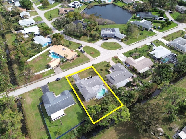 birds eye view of property featuring a water view and a residential view