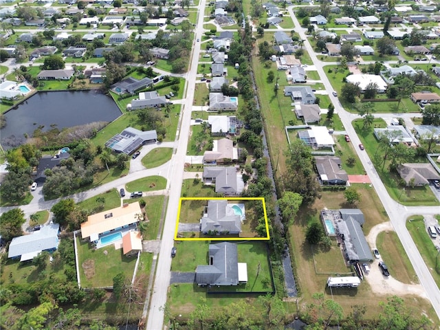 bird's eye view featuring a water view and a residential view