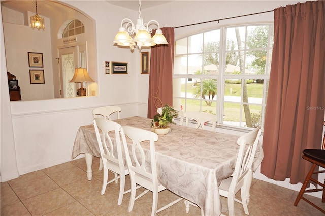 dining room featuring light tile patterned floors and a chandelier