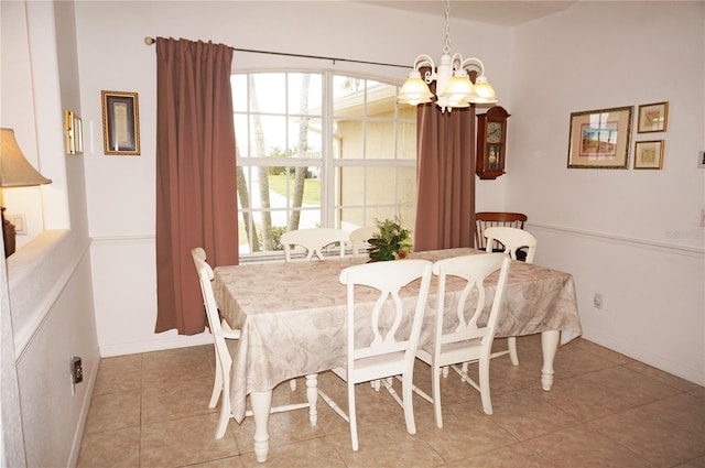 tiled dining space featuring a notable chandelier