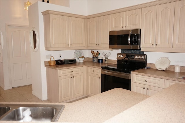 kitchen featuring stainless steel appliances and light tile patterned floors