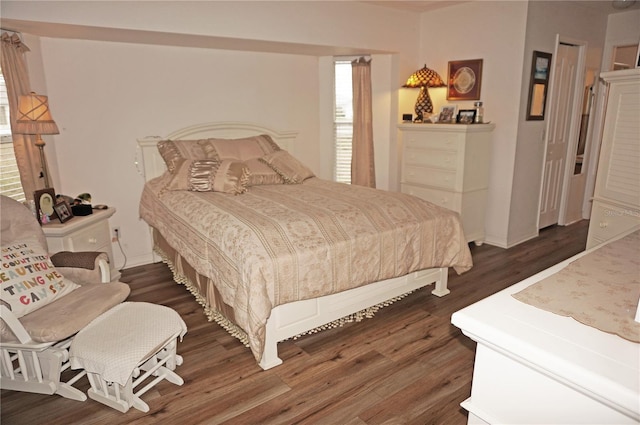 bedroom with dark wood-type flooring