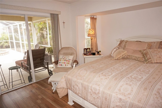 bedroom with multiple windows and dark hardwood / wood-style floors