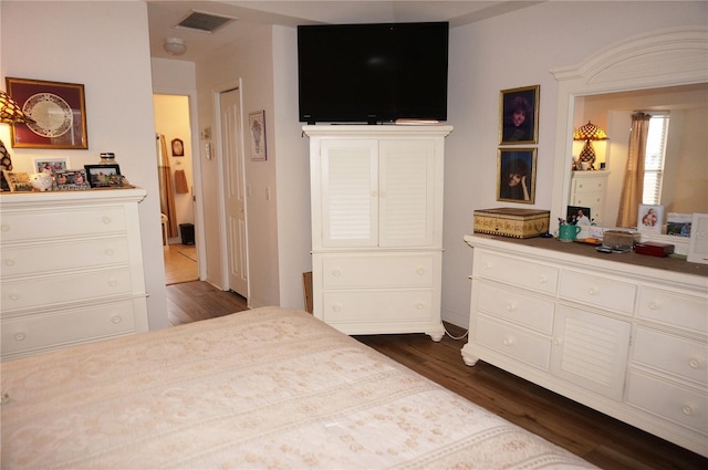 bedroom with dark hardwood / wood-style flooring