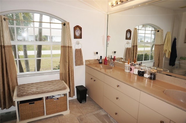 bathroom with vanity, toilet, and tile patterned flooring