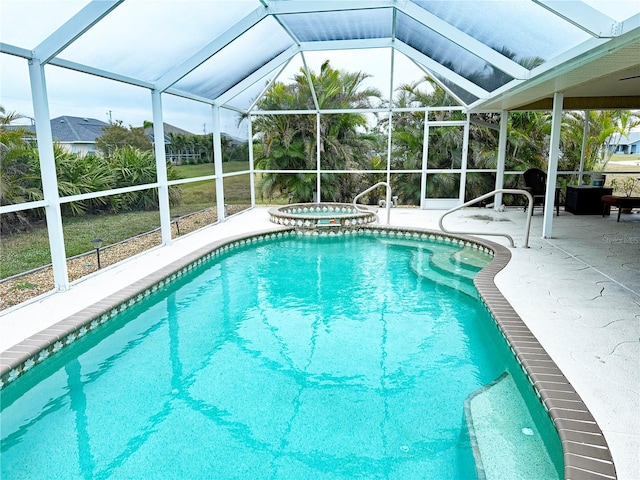 view of pool with a patio area, an in ground hot tub, and glass enclosure