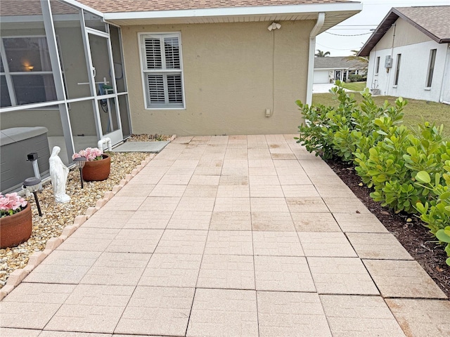 view of patio / terrace featuring glass enclosure