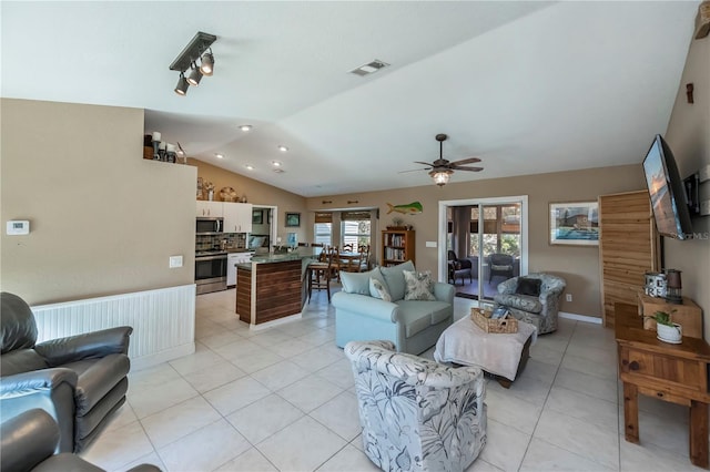 tiled living room featuring lofted ceiling and ceiling fan