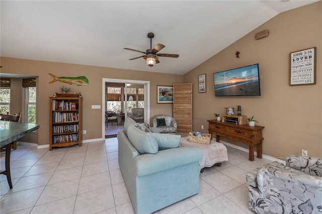 tiled living room with ceiling fan, plenty of natural light, and vaulted ceiling