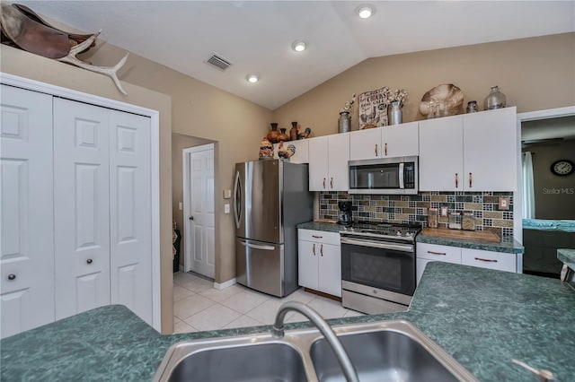 kitchen featuring light tile patterned floors, stainless steel appliances, sink, and white cabinets