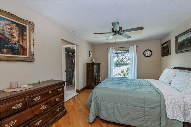 bedroom featuring ceiling fan, a textured ceiling, and light hardwood / wood-style floors